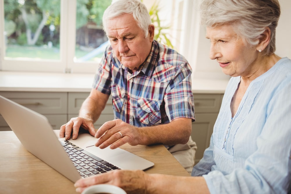 Senior couple using the computer to find hobbies and search the internet