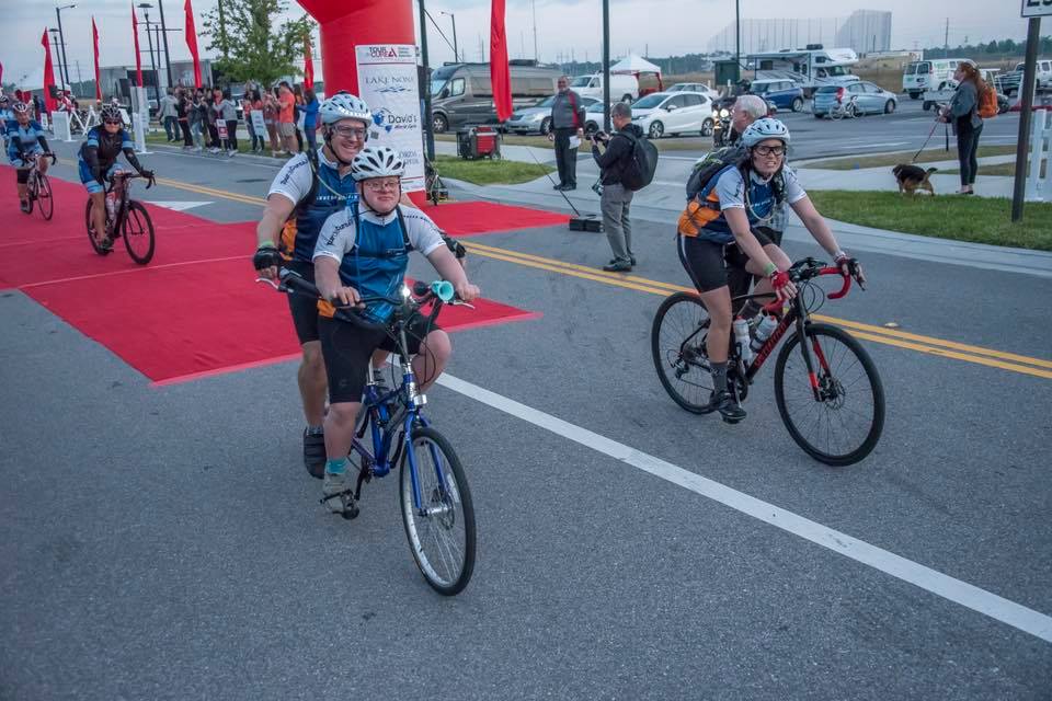 Father and son riding an adaptive bicycle