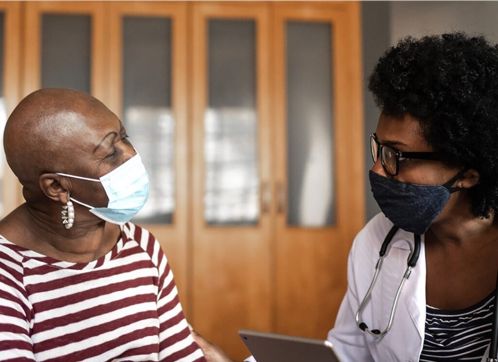 patient and doctor, both wearing masks