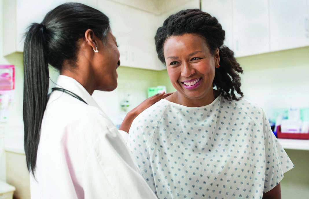women and doctor Female patient comforted by her doctor