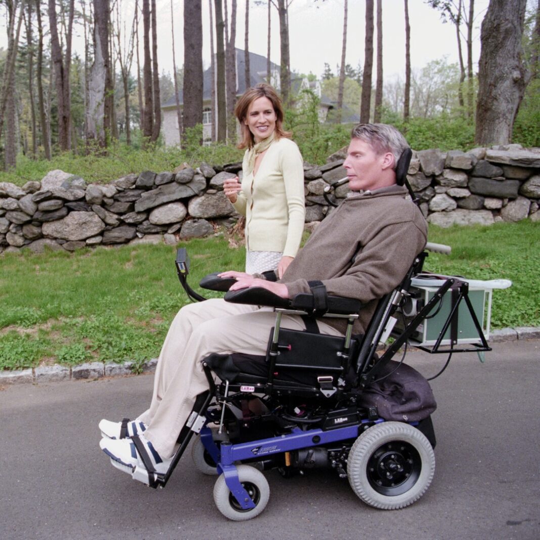 Dana and Christopher Reeve Foundation Dana Reeve walks beside Christopher Reeve using his wheelchair