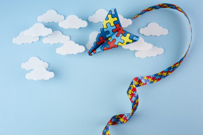 Autism puzzle paper airplane flying in sky