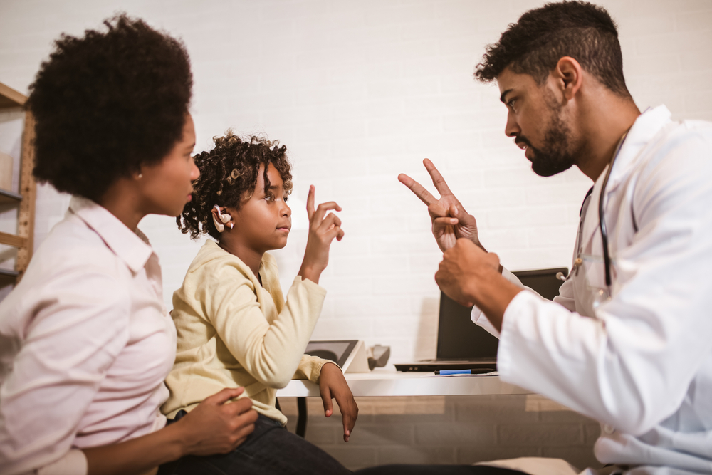 male physician using ASL with child with special health care needs