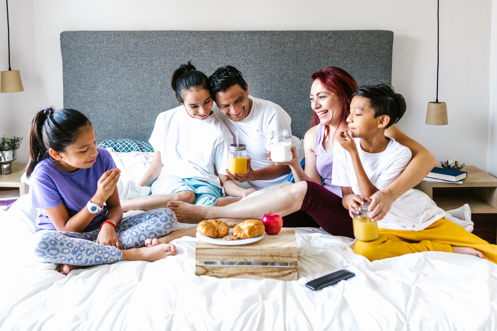 Hispanic family eating breakfast in bed, latinx disabilities