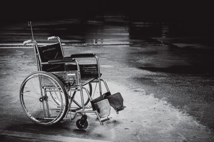 empty wheelchair in rainy street