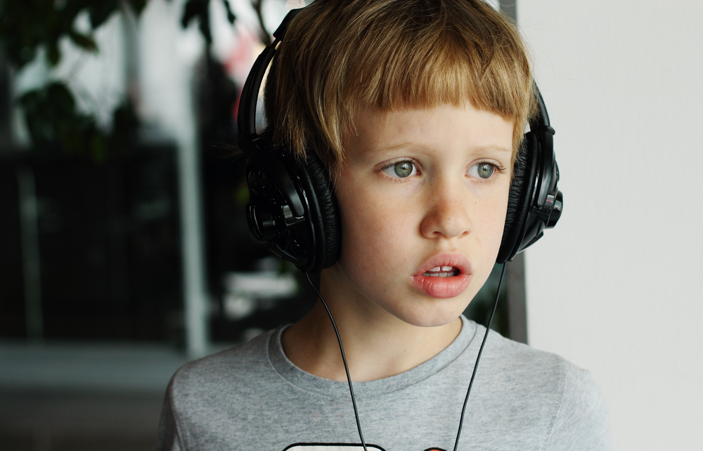 boy wearing noise-canceling headphones