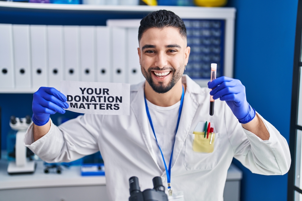 lab tech holding up donated blood