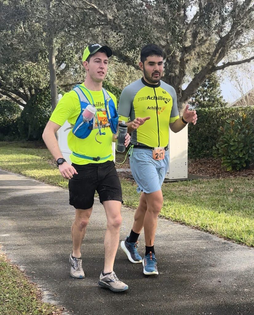 Greg, a guide, and Francesco, a blind athlete, running on the final day of the race