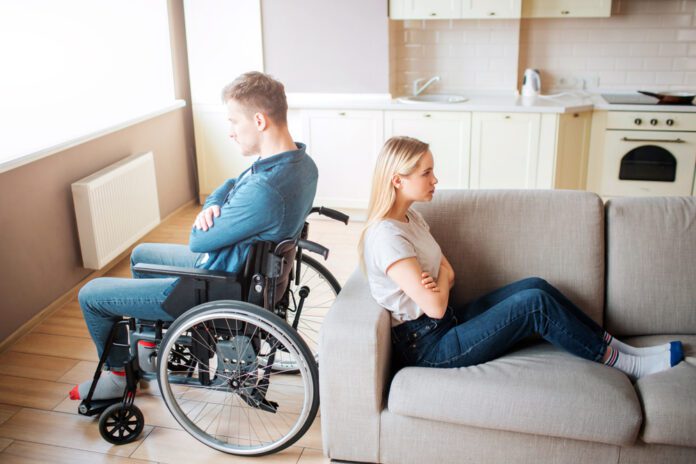 interabled couple with their backs to each other