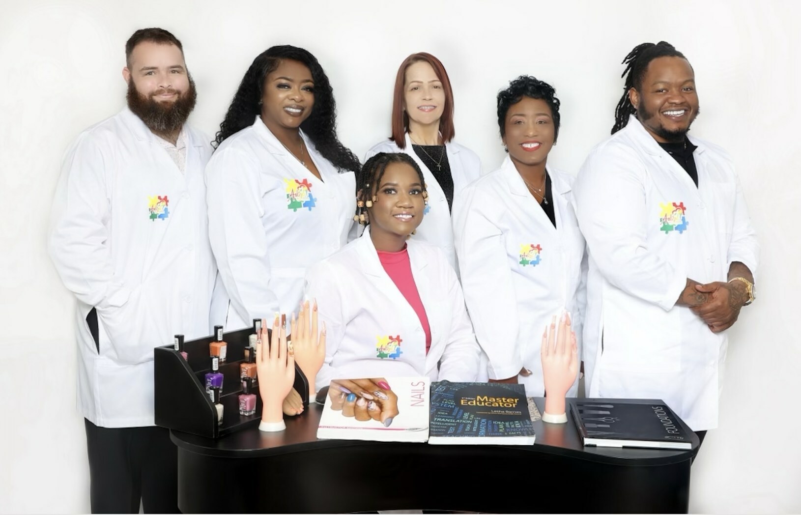 Aaliyah Thompson (seated) with her team from Aaliyah's Beauty Bar, an inclusive salon offering hair, nail and make-up services for all women. 
