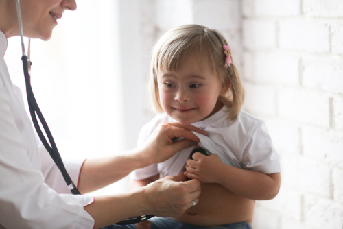 Doctor checking heart of a children with special health care needs