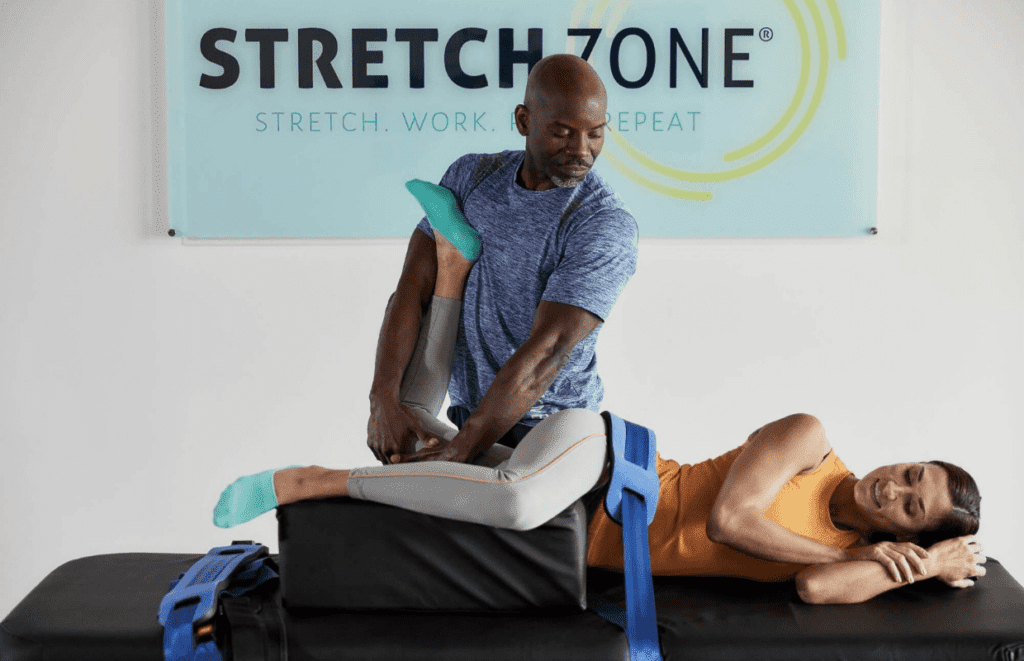 A stretch practitioner helps a client with stretch therapy.