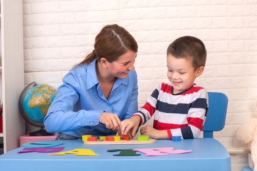 A mom and son work on at-home occupational therapy.