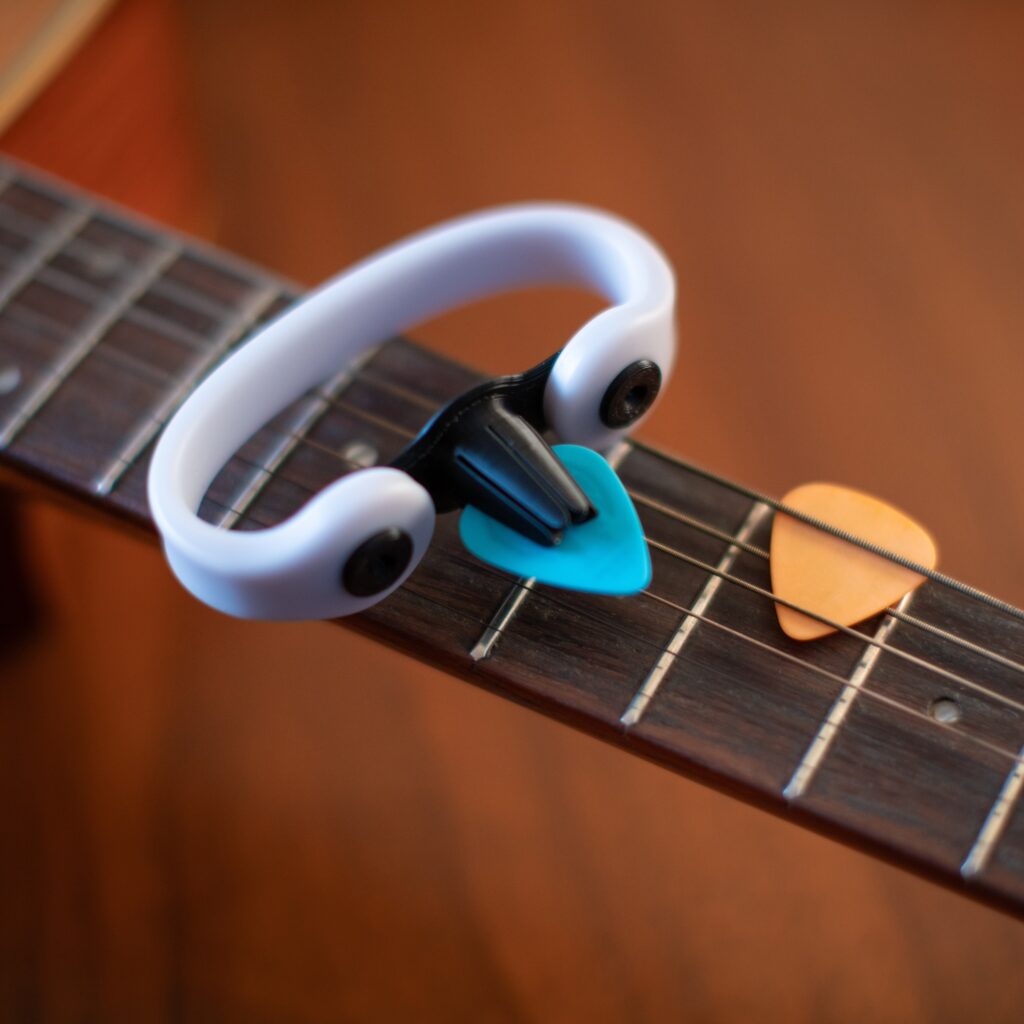 Image of an EaZyHold device called the Strumling to help hold a guitar pick