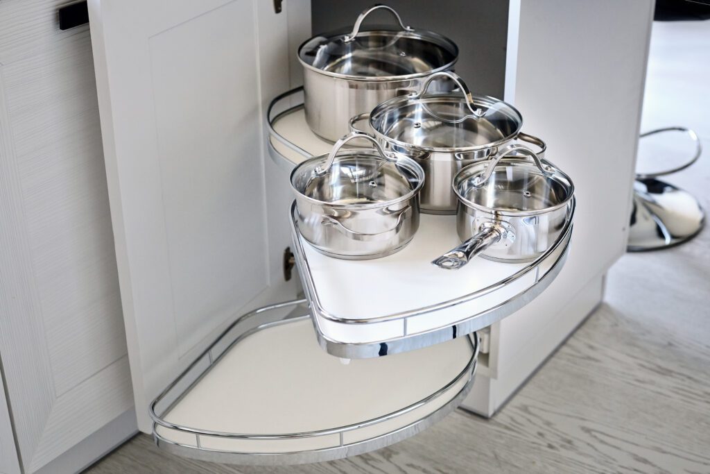Solution for a kitchen corner storage in cupboard. Corner unit with pullout shelves for cookware.