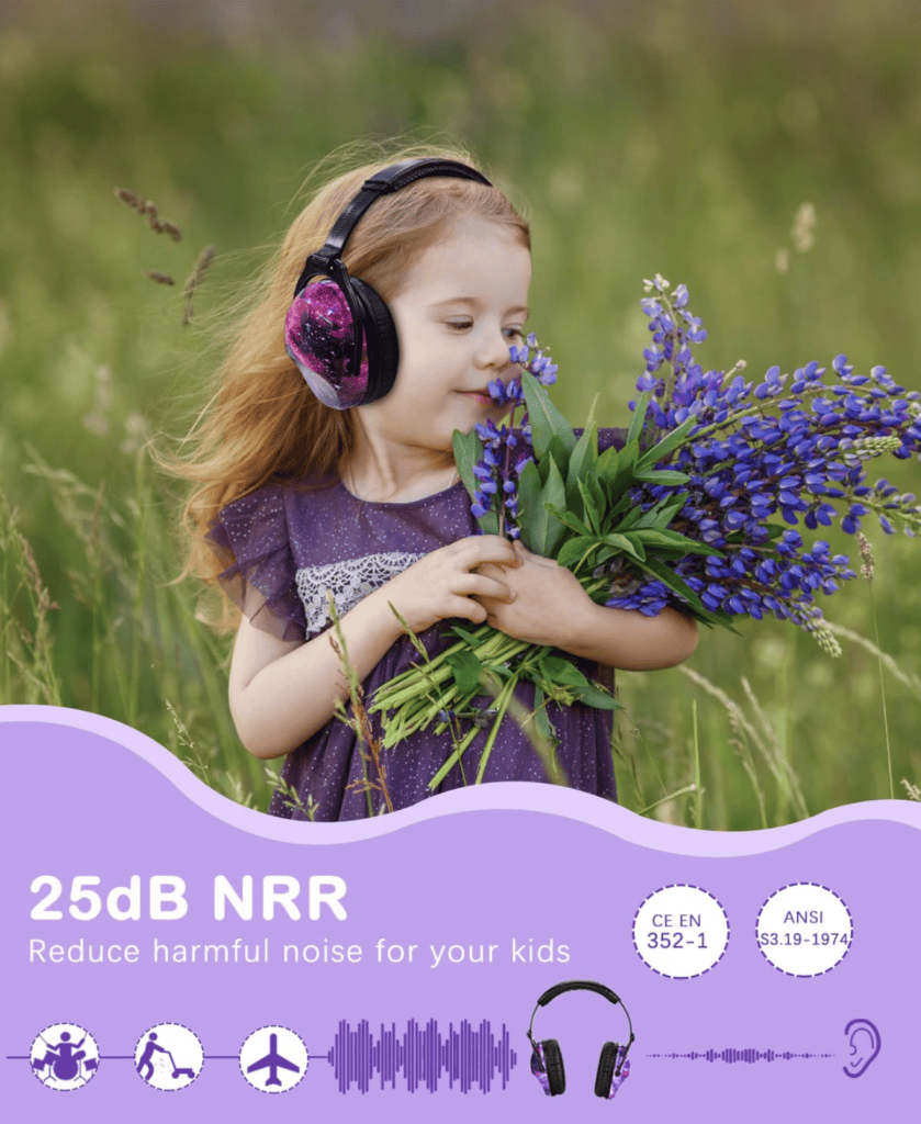 Small girl in field holding purple flowers with noise canceling headphone on.