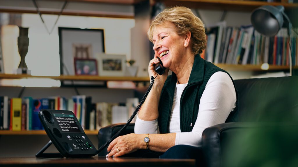 Senior woman using CaptionCall. Photo courtesy of CaptionCall.