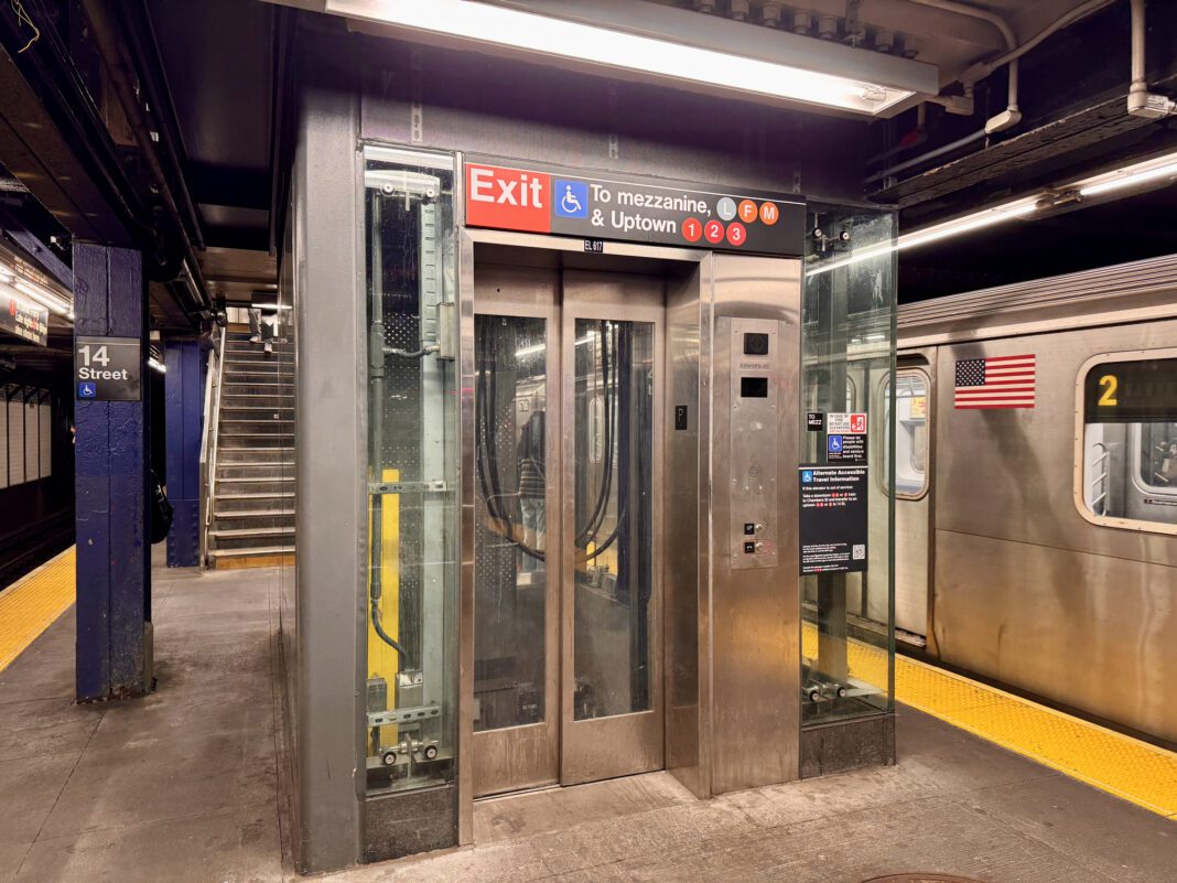 New York, NY USA - April 11, 2025 : "Exit" and "To mezzanine and Uptown" sign with wheelchair accessible symbol on subway platform at 14th Street station in Manhattan, New York City